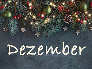 Schriftzug Dezember auf weihnachtlichem Grund