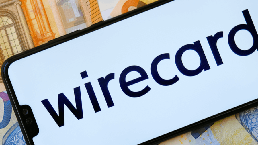 Wirecard-Logo auf einem Smartphone auf Geldscheinen