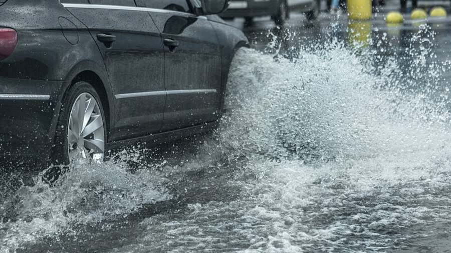 Unwetter: Auto f&auml;hrt durch Hochwasser