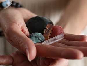 Frau h&auml;lt Heilsteine in der Hand