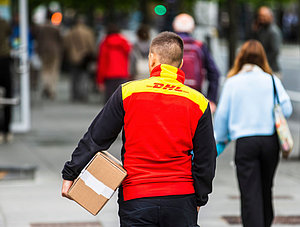 DHL Zusteller mit Paket