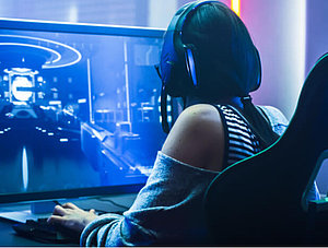 Gaming: Frau an Rechner beim Videospielen