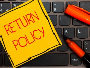 Auf einer Tatstur klebt ein Zettel mit "Return Policy"