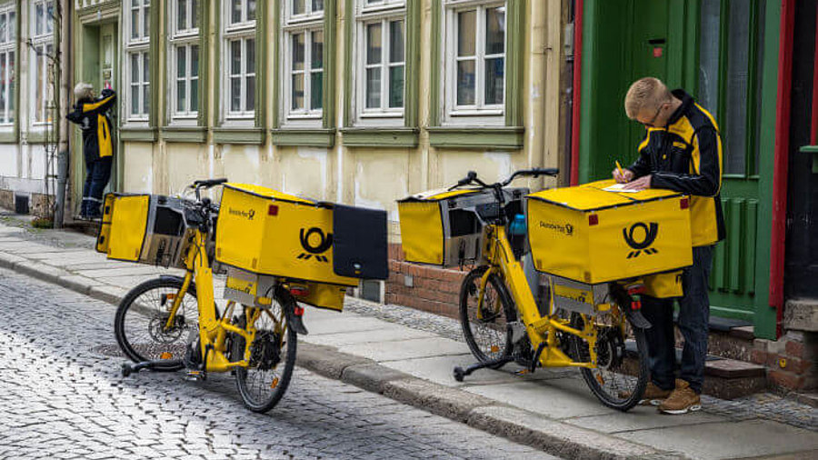 Zusteller der Deutschen Post am Zustellfahrad