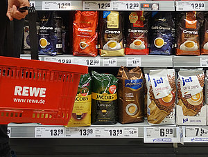 Kunde mit Einkaufskorb im Rewe-Supermarkt