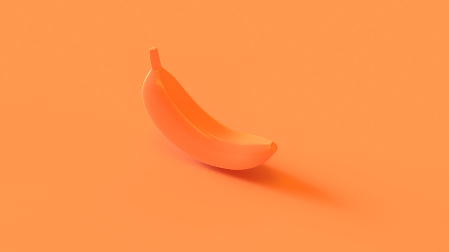 Eine orangene Banane vor orangenen Hintergrund