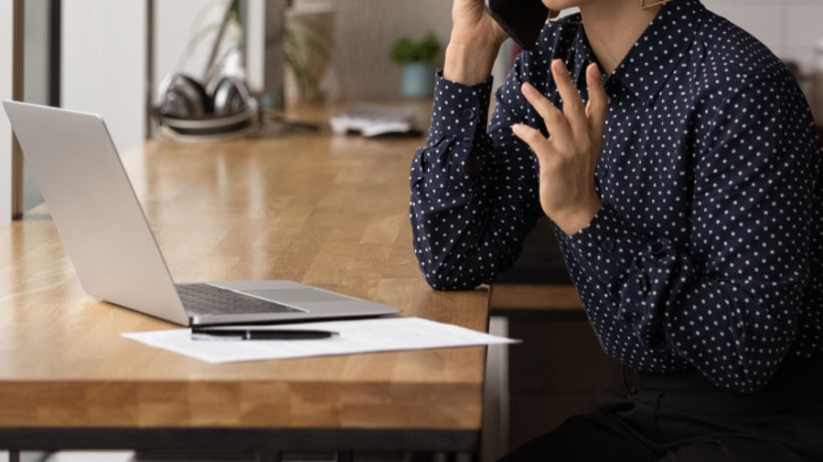 Frau am Laptop telefoniert