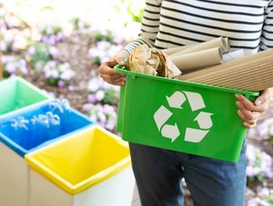 Frau hält Behälter für Recycling