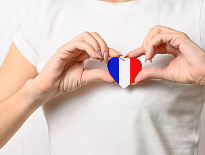 Hand hält Herz mit Frankreich Flagge