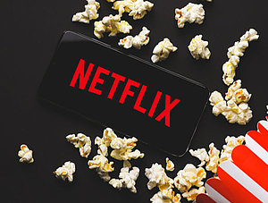 Netflix-Logo auf Smartphone mit Popcorn