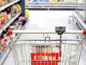 Einkaufswagen zwischen Supermarktregalen