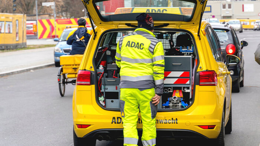 Mitarbeiter des ADAC vor einem Pannenservice-Fahrzeug