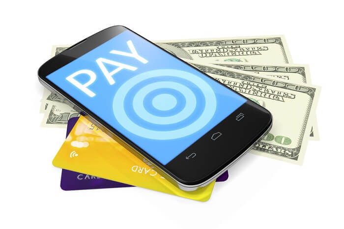 smartphone, dollar notes and credit cards for mobile payment