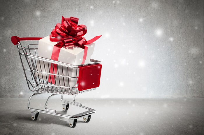 christmas gift in cart - wall and snow