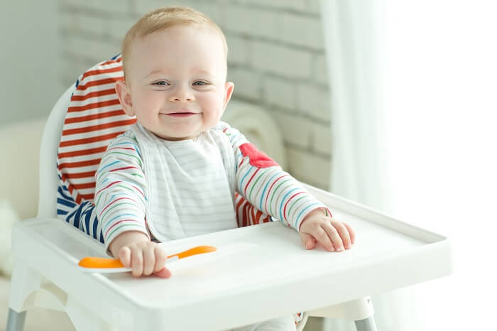 Niedliches Baby im Kinderstuhl