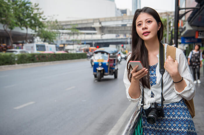 Chinesische Frau wartet auf Mitfahrgelegenheit